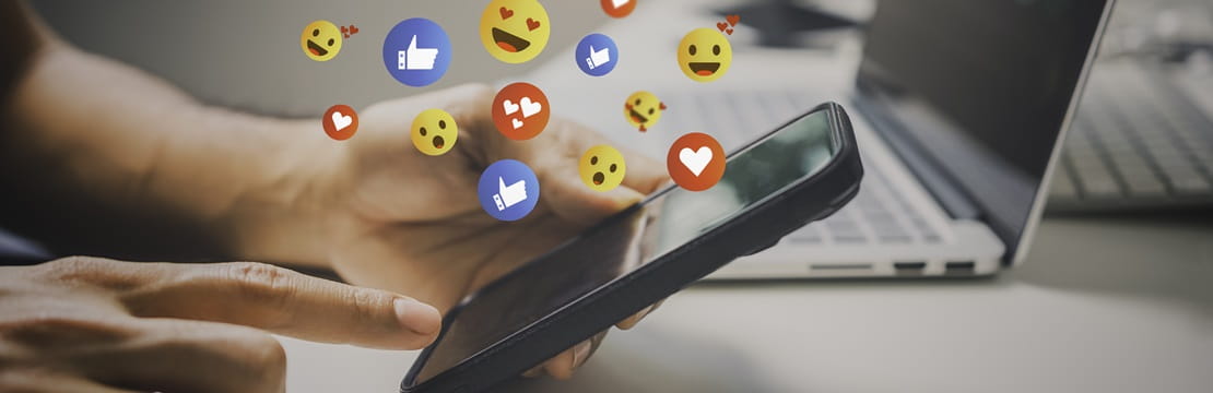 Man accessing social media platforms through his smart phone.